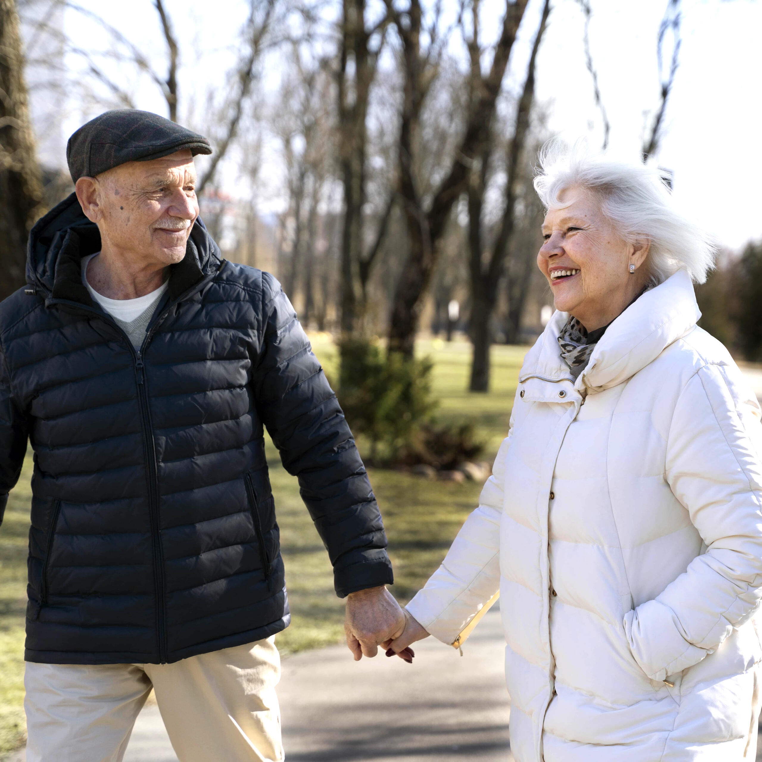 Elderly couple walking in park wearing Assurewear pants